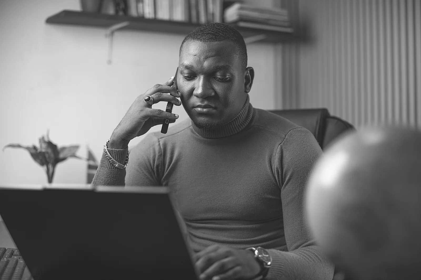 Black-and-white portrait, at the desk of David Jeng