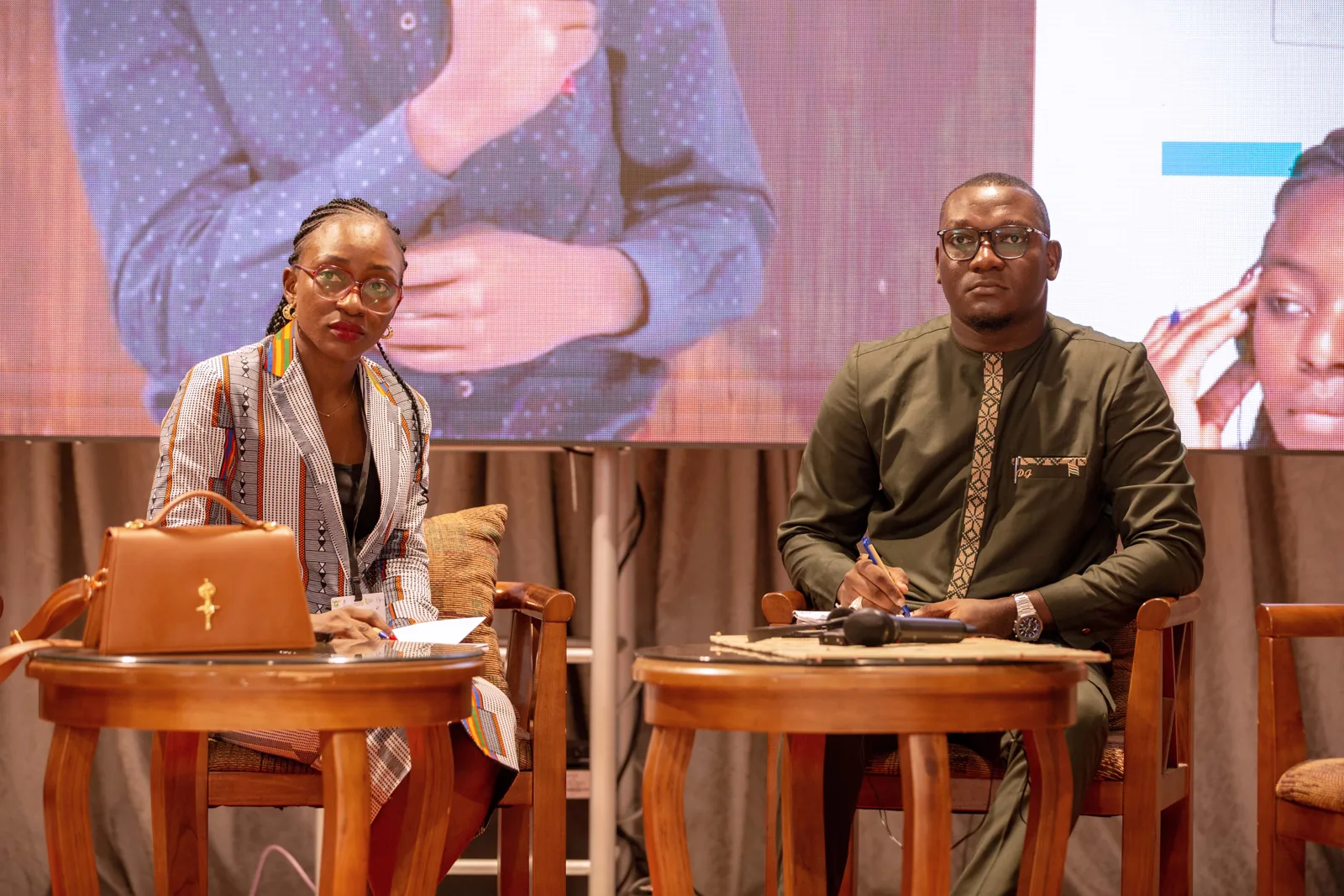 Speakers in conversation on stage