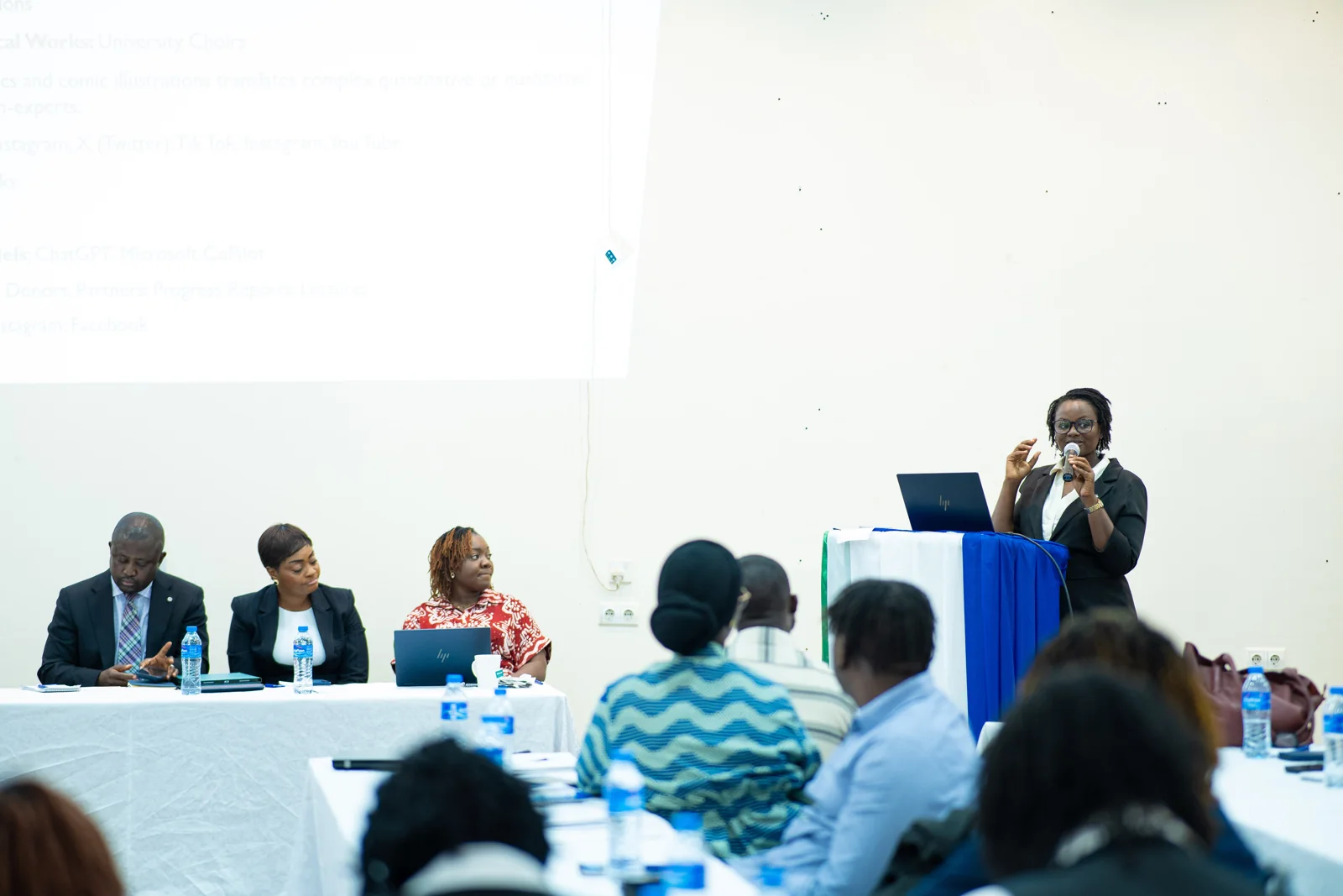 A speaker addressing participants from the lectern