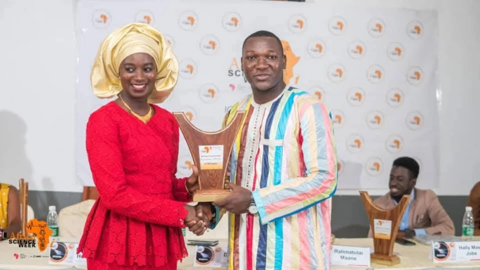 Two participants posing with an award
