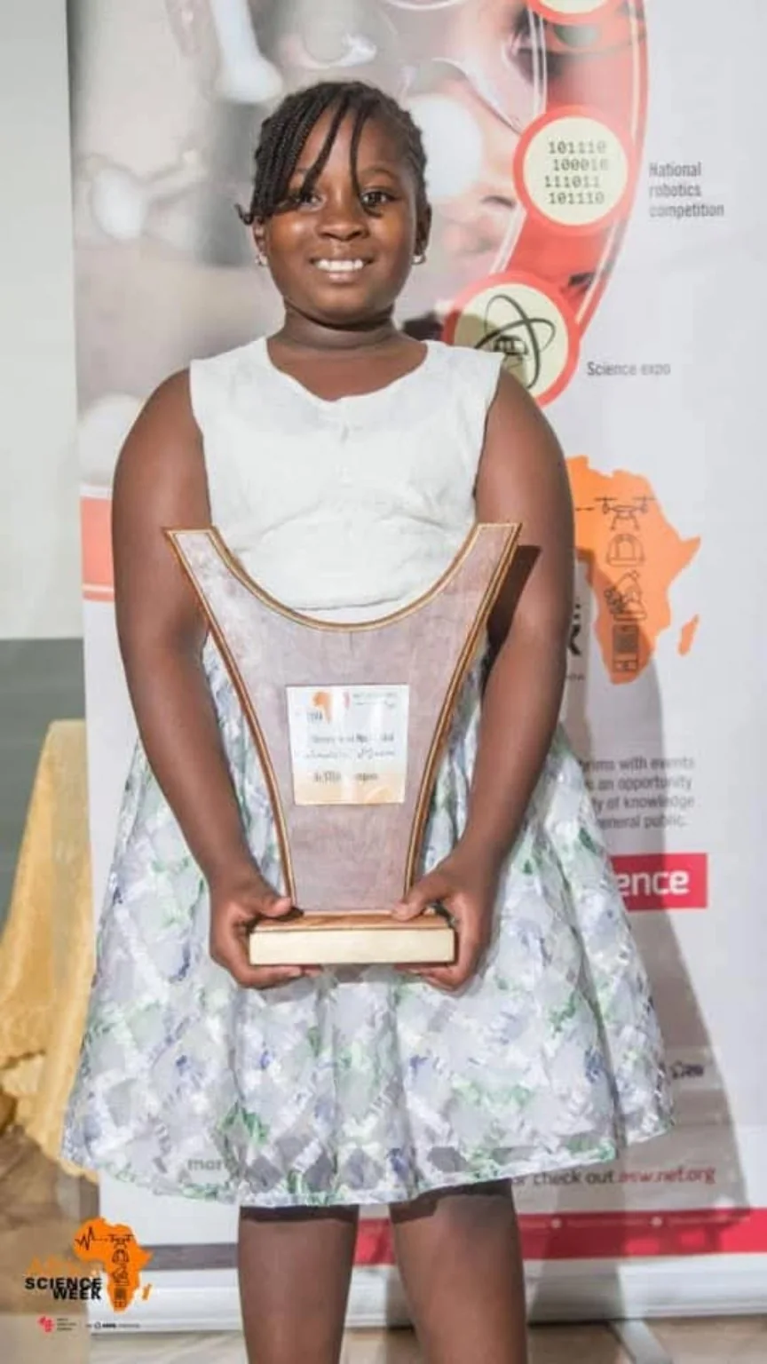 A participant holding an Africa Science Week award